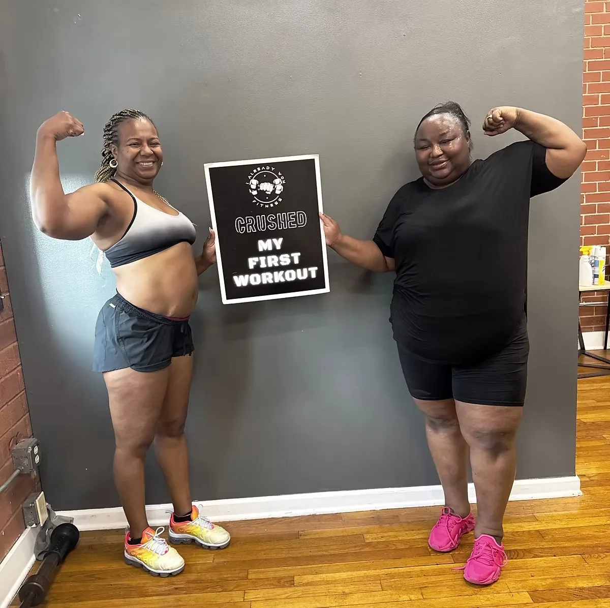 Two members celebrating their first workout